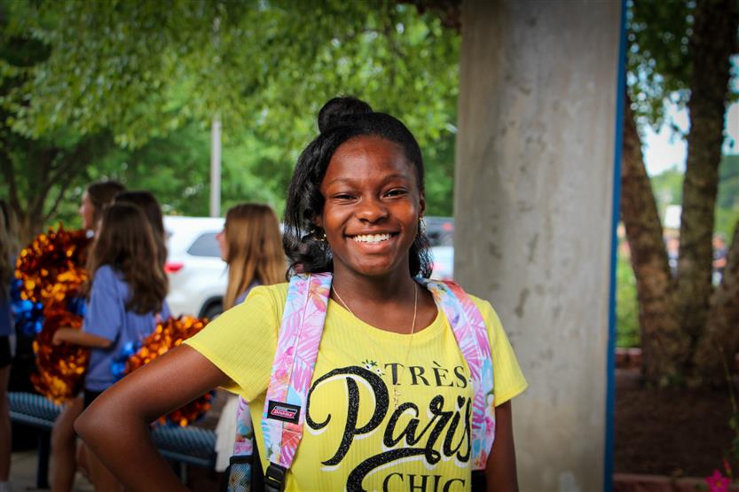 A student smiles